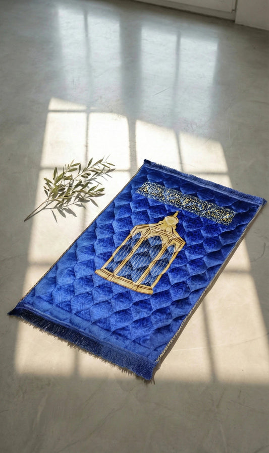 Blue textured soft velvet jay namaz mat with gold design on a light floor