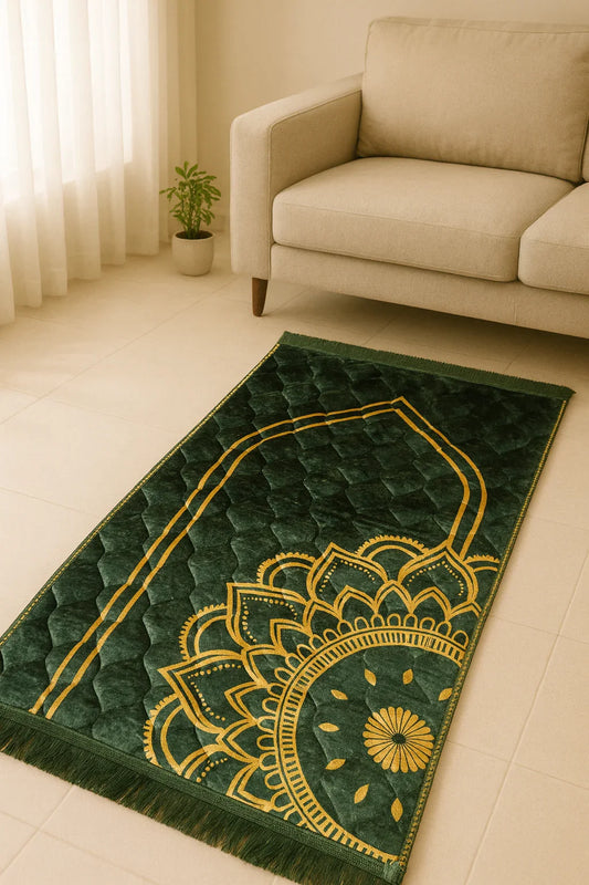 Green Islamic prayer mat with golden mandala design on tiled floor next to beige sofa and plant