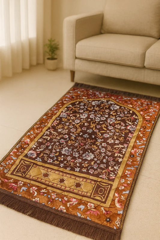 Beautiful brown Islamic prayer mat with intricate floral patterns placed on the floor near a beige sofa