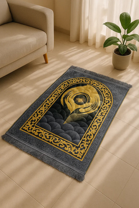Luxury grey velvet Islamic prayer mat with soft texture and golden arch design placed on beige tiled floor near sofa and plant