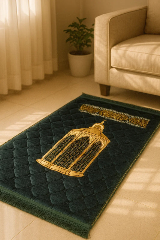 Dark green Islamic prayer mat with gold mosque design placed on beige floor near cream sofa and potted plant