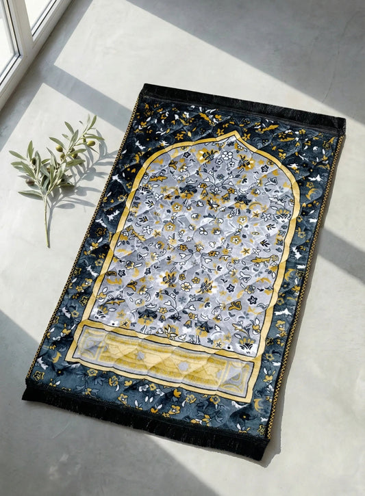 soft velvet prayer mat in pakistan  with intricate design on a light gray floor.